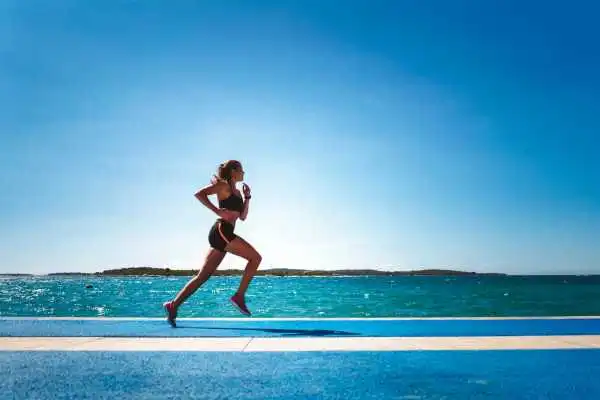 Woman running showing strong leg muscle Dunfermline